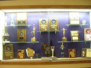 a display case filled with trophies and plaques