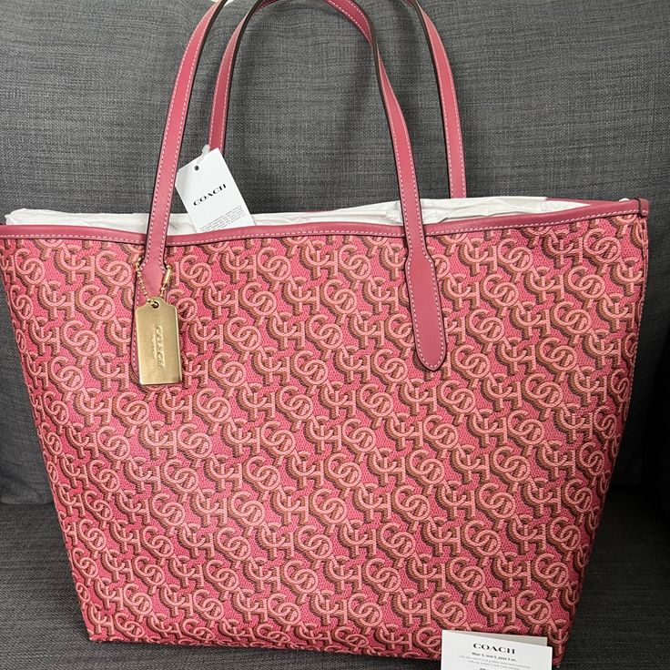 Brand New With Tag Coach Signature Tote Handbag Purse Grain Leather Rouge (Pink) Color Polished Gold Hardware Coach Logo & Medallion On The Front Snap Closure On The Top Interior: One Zip Pocket Approximately 13”-17”L X 11.5”H X 6"W Durable & Roomy Smoke & Pet Free Home Retail Price $398+Tax Please See My Entire Collection . Double Handle Monogram Canvas Bag With Logo, Double Handle Monogram Canvas Bags With Logo, Large Capacity Monogram Canvas Bag, Luxury Pink Coated Canvas Shoulder Bag, Monogram Canvas Shopping Bag, Luxury Pink Coated Canvas Bag, Pink Coated Canvas Top Handle Bag, Pink Top Handle Bag In Coated Canvas, Designer Pink Coated Canvas Shoulder Bag