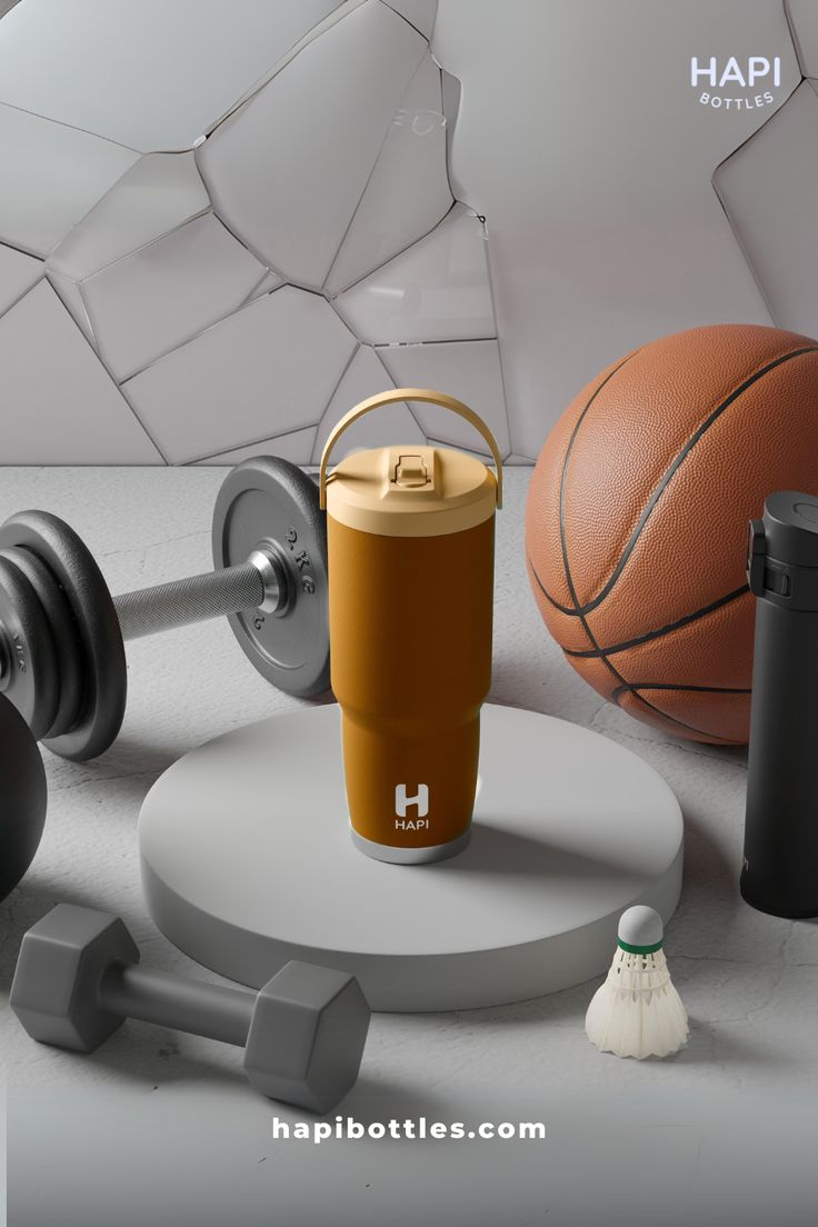 an assortment of gym equipment including dumbbells, a bottle of water and a basketball