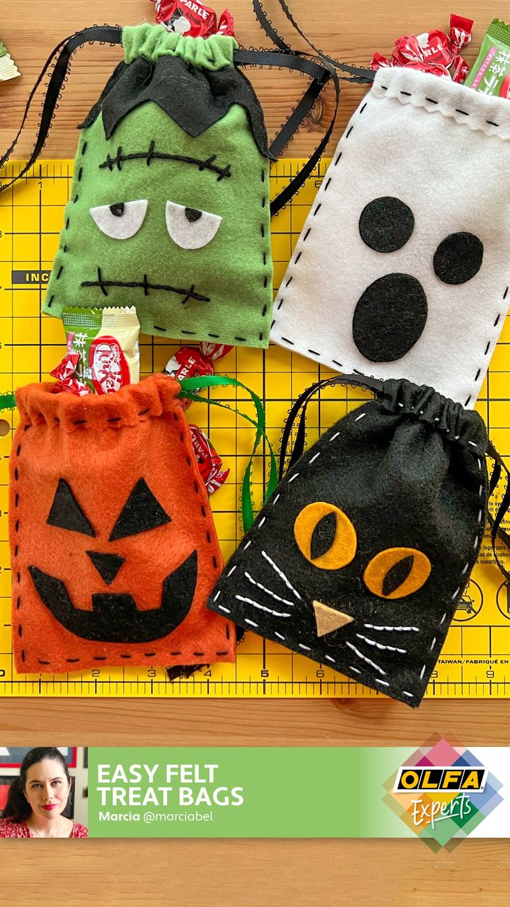 four halloween treat bags on a cutting board