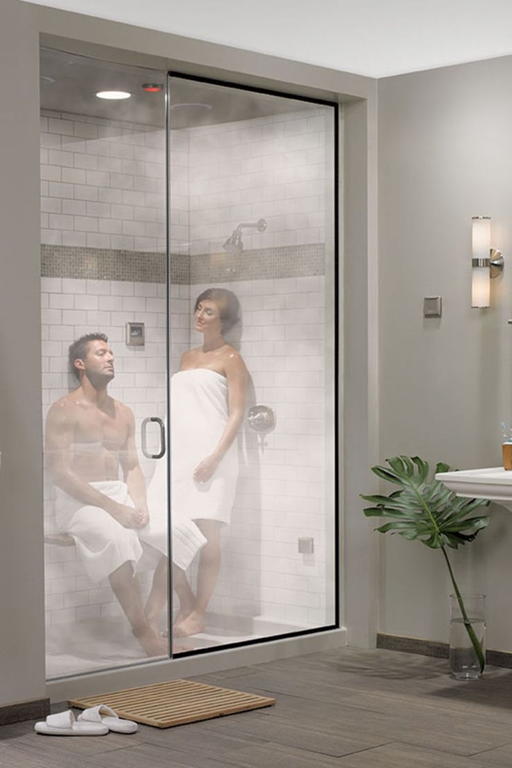 a man and woman in the shower looking at each other