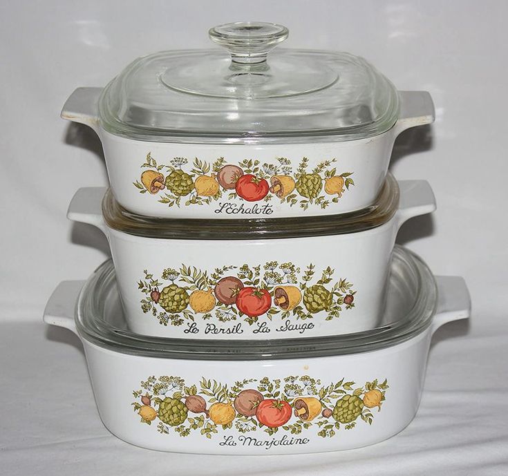 three white casserole dishes are stacked on top of each other with glass lids