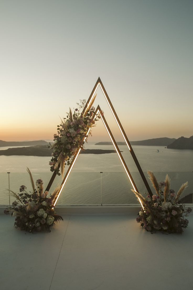 wedding arch, wedding flowers, wedding ceremony Wedding Arbor Unique, Triangle Arch With Neon Sign, Unique Arches Wedding, Wooden Triangle Backdrop, Wedding Arch Ideas Triangle, Wedding Arch Circular, Geometric Wedding Arch, Engagement Arch, Unique Wedding Arch Ideas