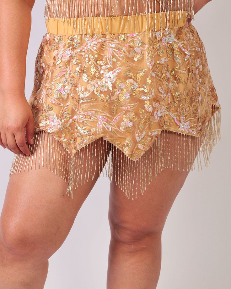 Let the sun-kissed hues and playful fringe on the Golden Hour Fringe Skirt highlight your style! Bask in the radiant glow of its sequin accents, casting an iridescent shimmer from every angle. Non-scratch waistband Soft interior lining 95% Polyester 5% Spandex Gold Fringe Skirt, Gold Skirt For Festivals, Spring High Waist Fringe Mini Skirt, Beach Mini Skirt With Fringe, Glamorous Gold Mini Skirt, Body Chain Harness, Couples Accessories, Glitter Glasses, Festival Gear