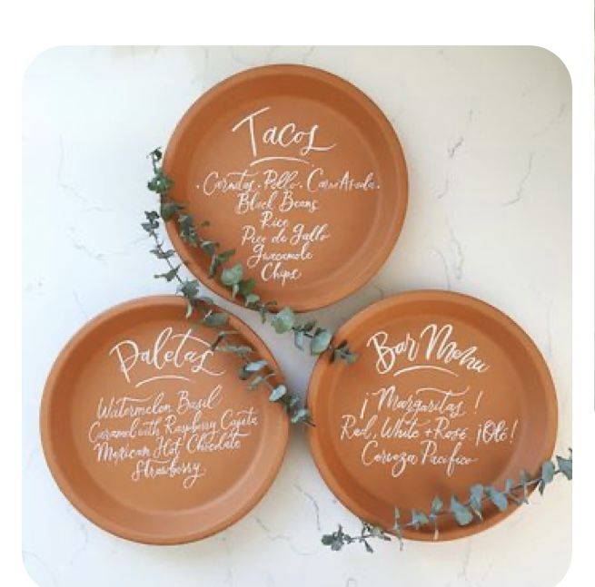 three orange plates with names on them