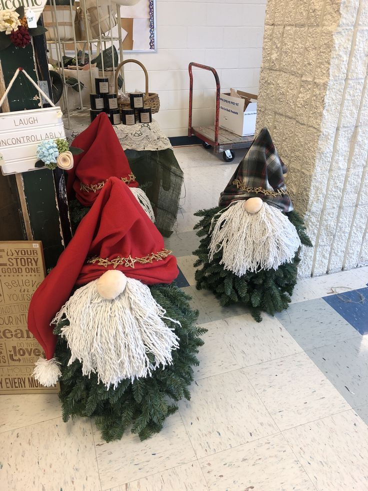 two gnomes made out of fake christmas trees