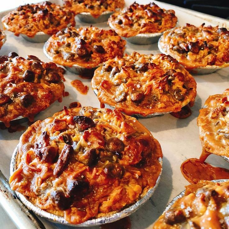 a tray filled with lots of tasty looking food on top of a stovetop