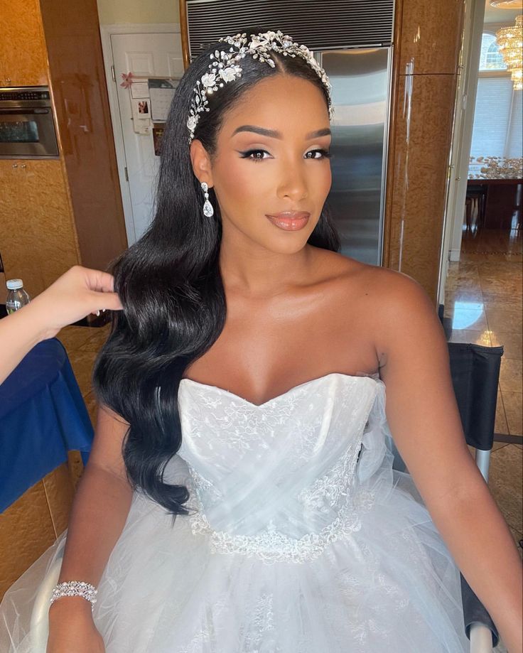 a woman in a wedding dress getting ready to go into her bridal gown for the ceremony