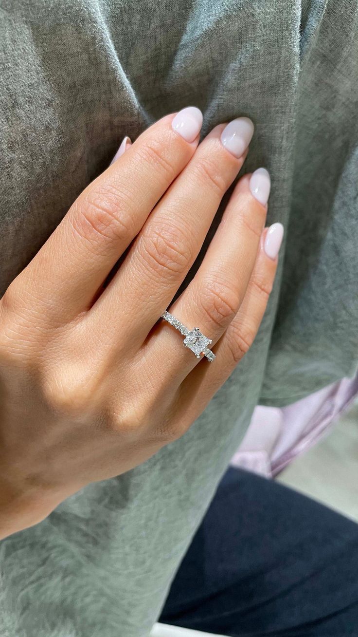 a woman's hand with a diamond ring on it