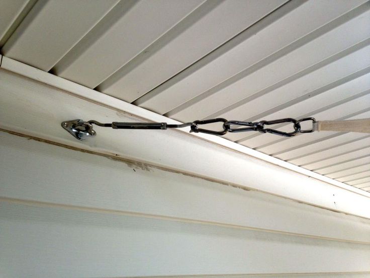 a chain is attached to the side of a house's roof with a hook