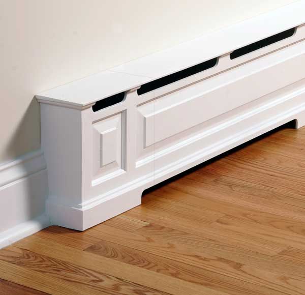 a white radiator sitting on top of a hard wood floor