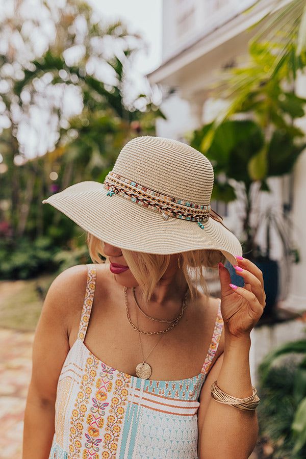 - Live your best beach life with this trendy raffia hat! - Woven material - A woven band featuring browns, peach, and turquoise and a tie detail - Dangling seashell and starfish charms - Hat Dimensions: - Length-16 Inches - Width- 15.5 Inches - Height-4 Inches - Cranial Circumference- 22 Inches - Brim Width- 4 Inches Beachy Beige Straw Hat For Beach Season, Lightweight Cream Straw Hat For Beach, Lightweight Cream Straw Hat For The Beach, Bohemian Sun Hat For Beach Season, Beige Beach Hat For Beach Season, Beachy Beige Sun Hat For Vacation, Beige Beachy Sun Hat For Vacation, Cream Summer Sun Hat For Beach, Cream Summer Sun Hat For The Beach