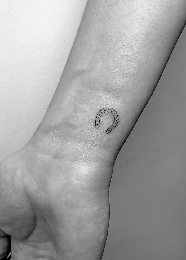 a black and white photo of a person's foot with a tattoo on it