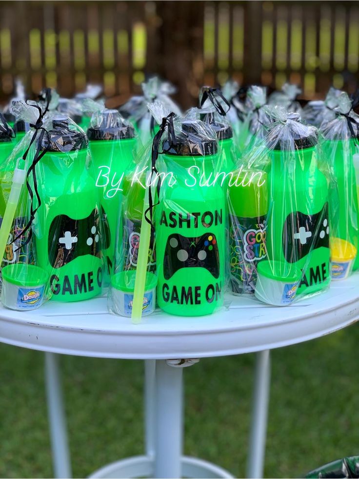 green bags filled with game controllers sitting on top of a table