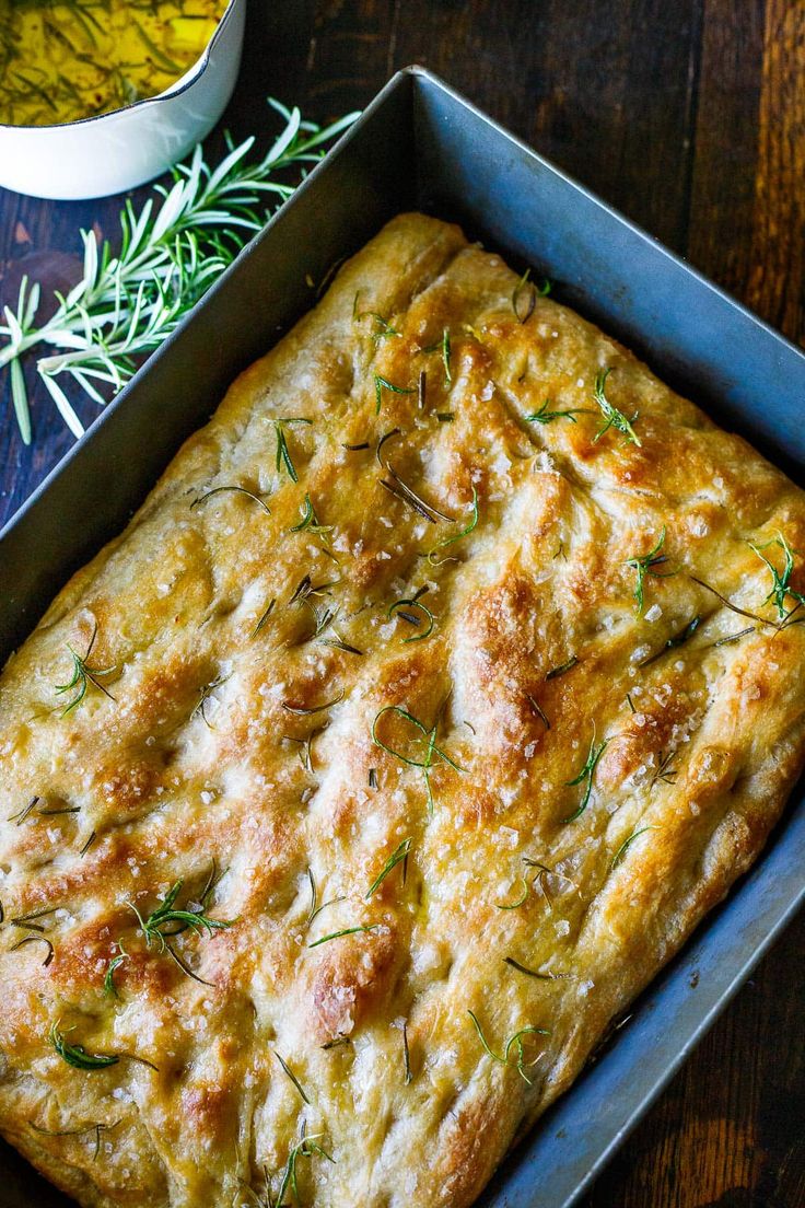 a square casserole dish with herbs on top