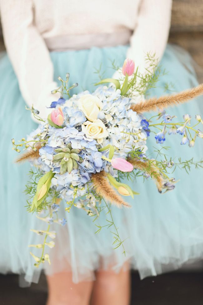 a woman holding a bouquet of flowers in her hands