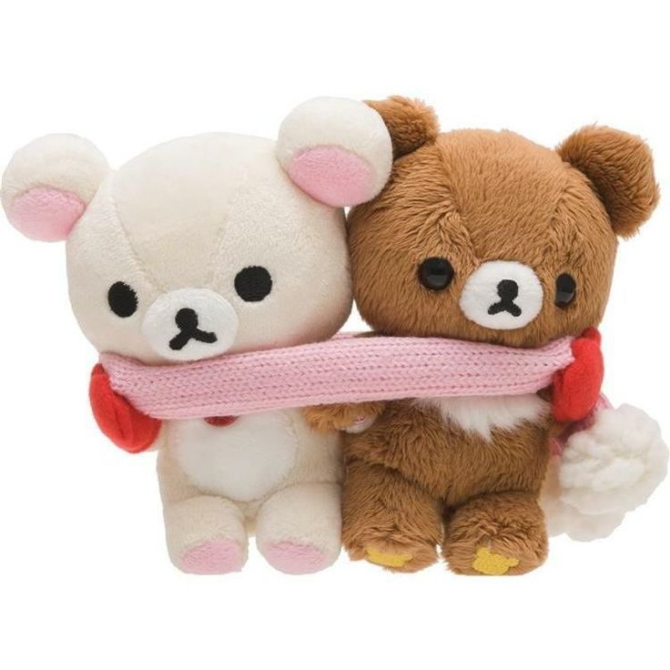 two teddy bears are holding on to each other with a pink scarf around their neck