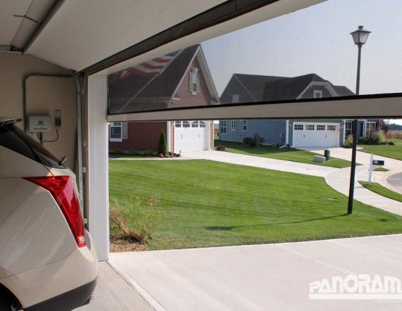 a white car parked in front of a house