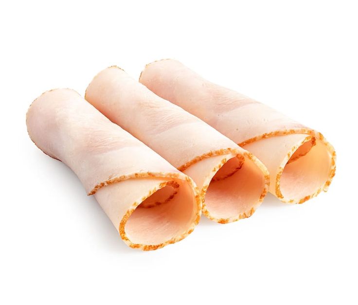 four pieces of raw chicken on a white background