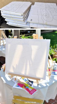 an easel sitting on top of a table covered in paper