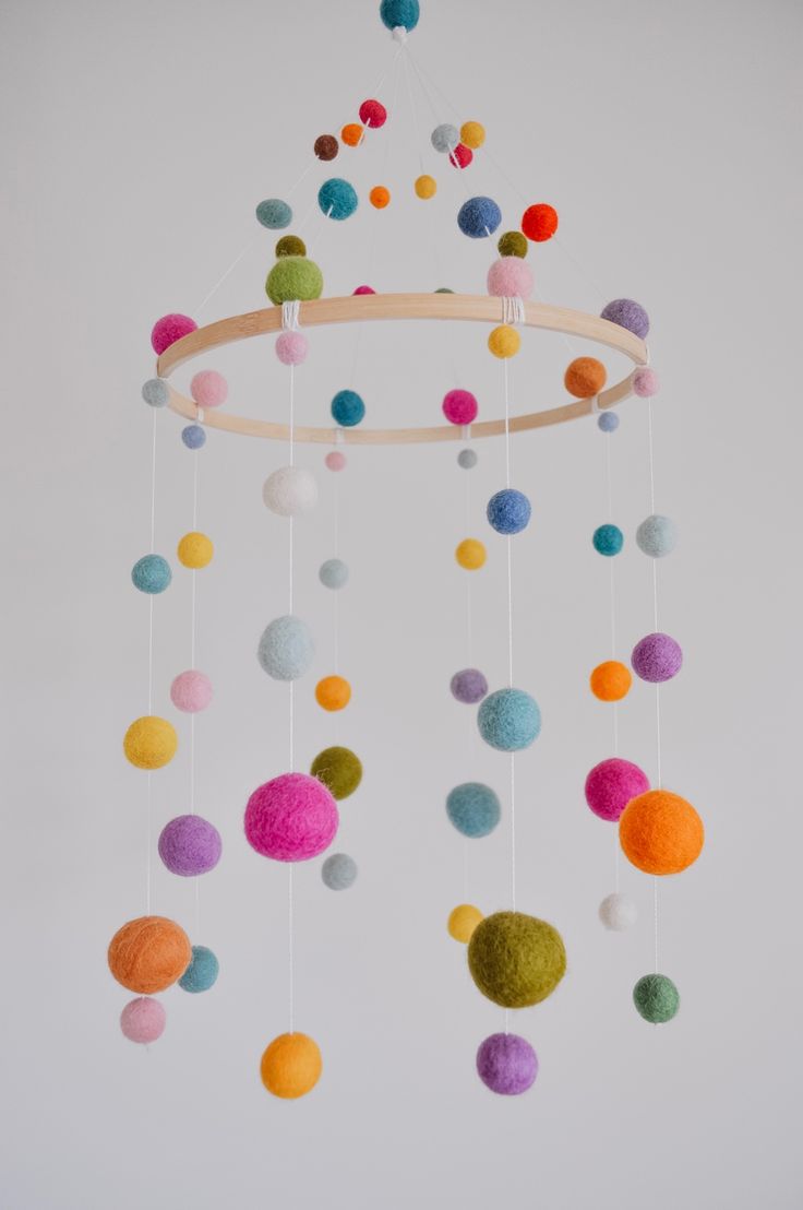 a mobile with multi colored balls hanging from it