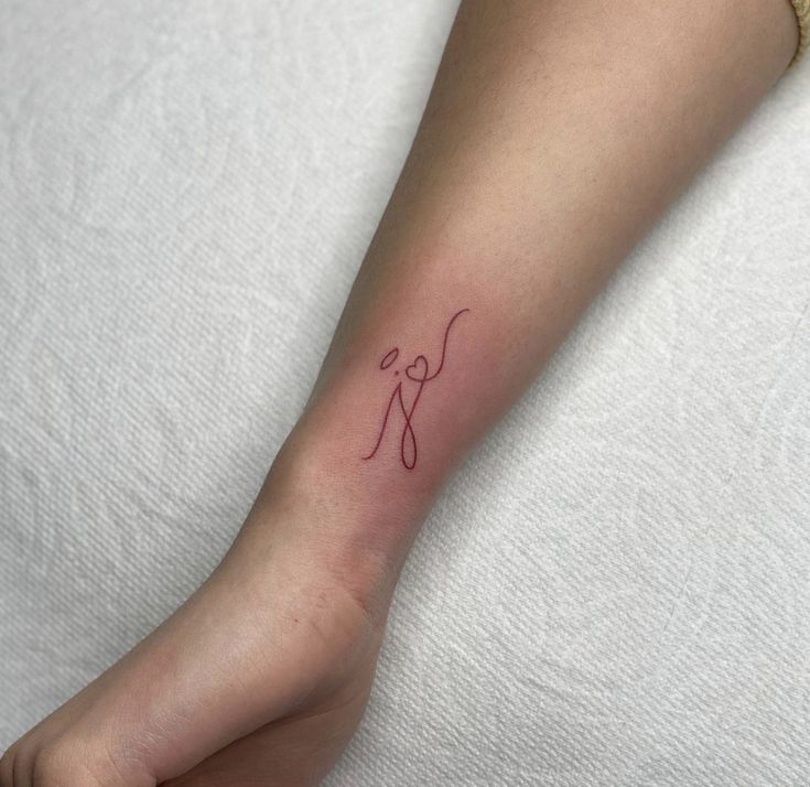 a woman's foot with a small tattoo on the left side of her leg