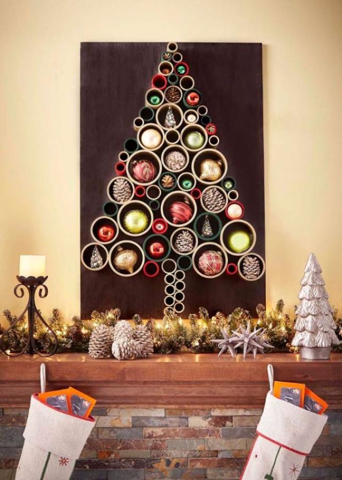 a decorated christmas tree with stockings hanging from it's sides in front of a fireplace