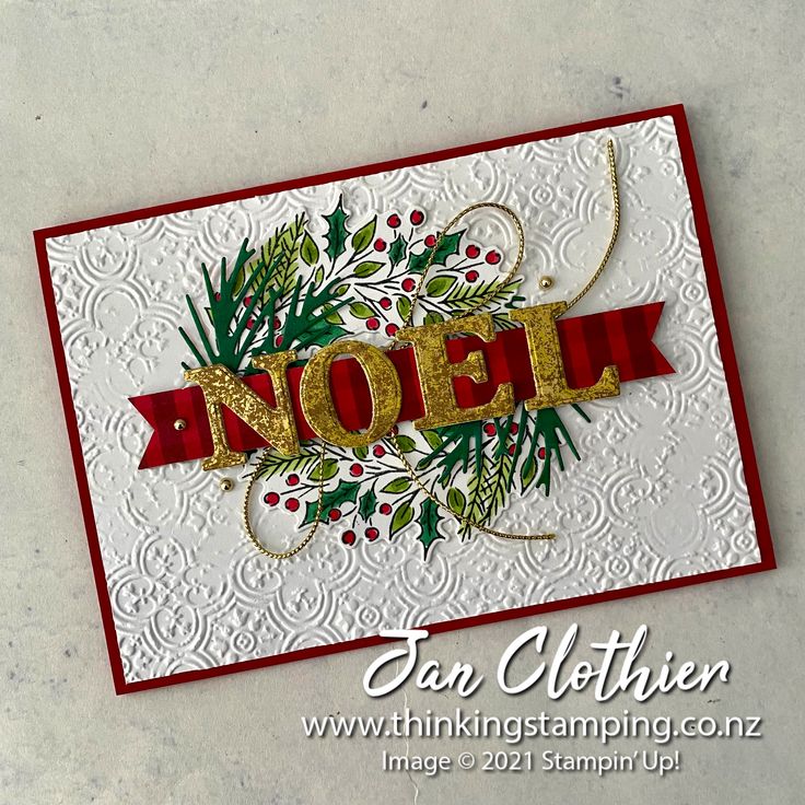 a close up of a christmas card with the word noel on it and holly decorations