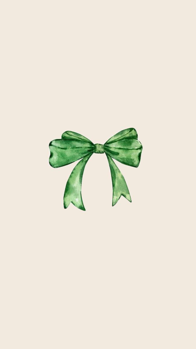 a green bow on top of a white wall