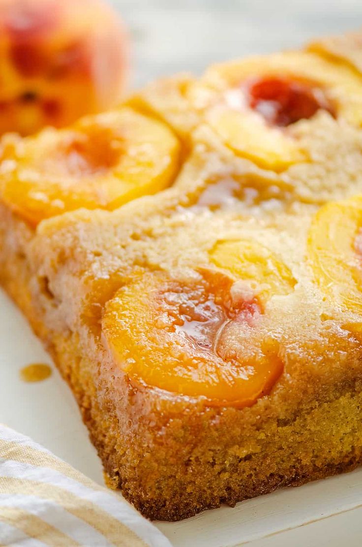 a close up of a piece of cake on a plate with the words peach upside down cake