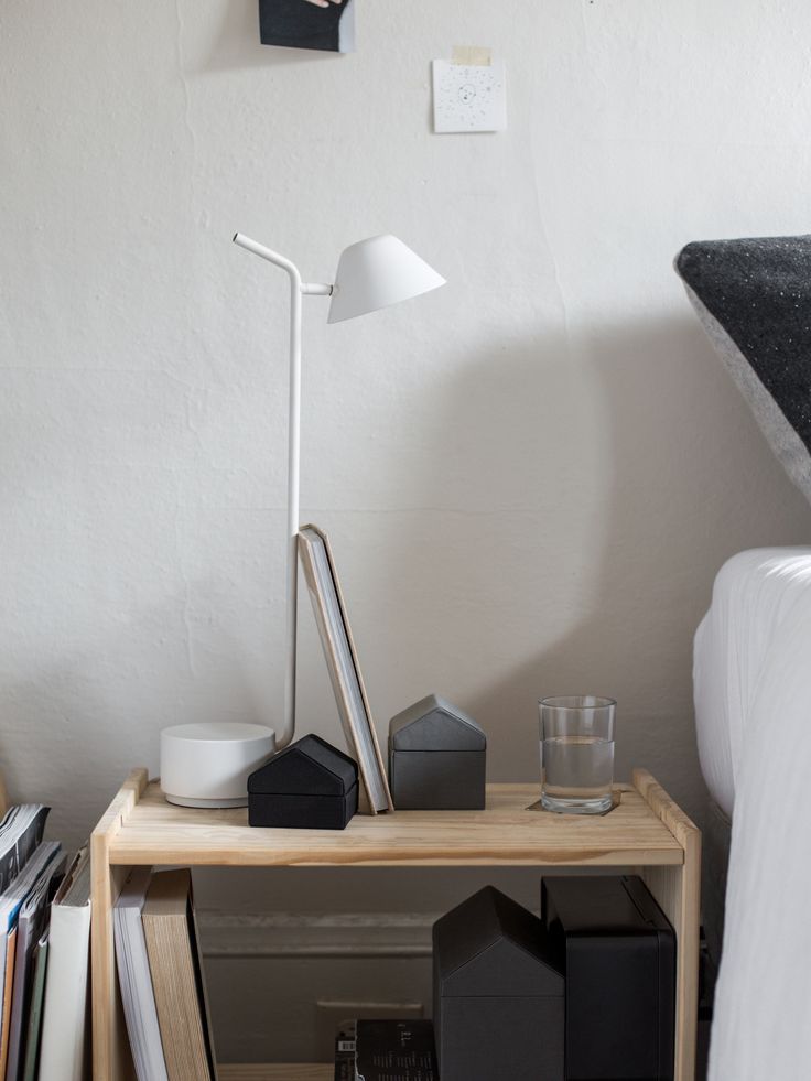 a nightstand with various items on it in a bedroom