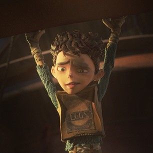 an animated character is hanging upside down from the ceiling with his hands in the air