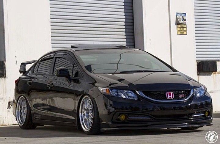 a black car parked in front of a building