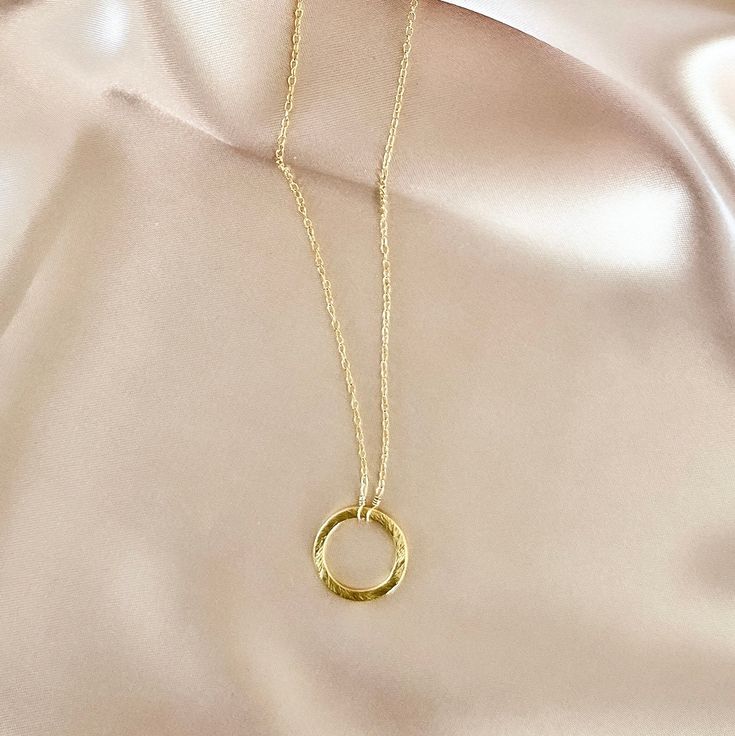 Our signature gold circle necklace is designed for layering over any necklace in our collection. Handmade, tarnish resistant 14k gold plated chain. Adjustable between 16"-18". Dainty Gold Chain Round Charm Necklace, Everyday Round Charm Necklace With Cable Chain, Gold Charm Necklace With Cable Chain, Gold Charm Necklaces With Cable Chain, Gold Necklaces With Delicate Open Circle Chain, Gold Circular Jewelry With Cable Chain, Gold Open Circle Clavicle Chain Jewelry, Gold Clavicle Chain Jewelry With Open Circle, Gold Clavicle Chain Jewelry In Open Circle Shape