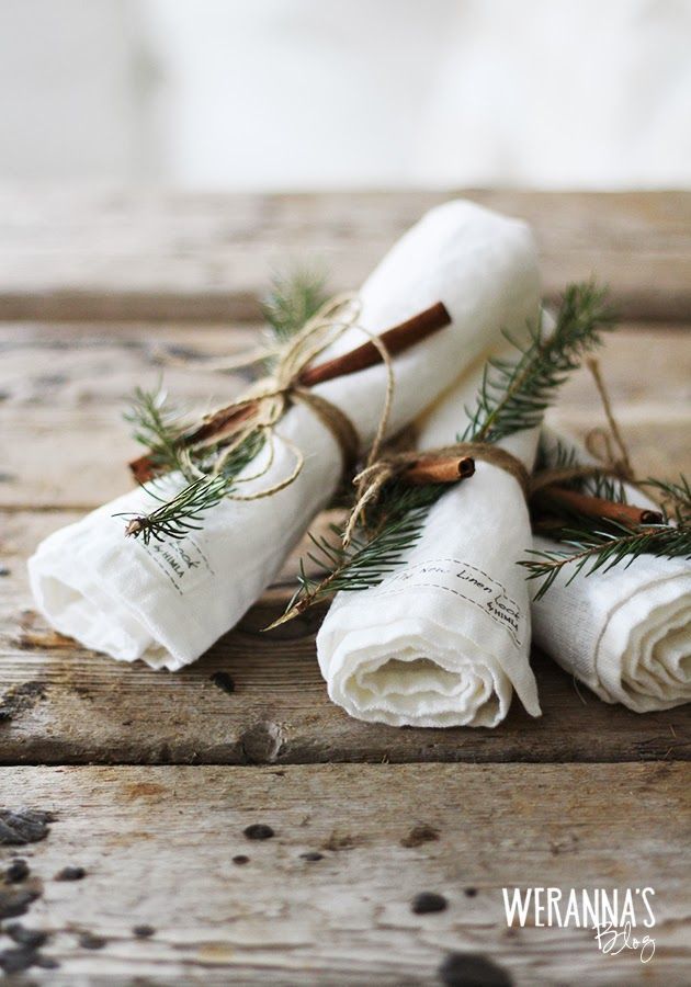 three napkins wrapped in twine and tied with twine on top of each other