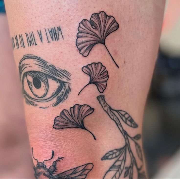 a close up of a person's leg with tattoos on it and an eye