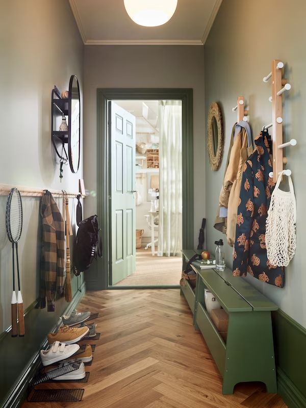 the hallway is clean and ready to be used as a storage area for coats, scarves and shoes