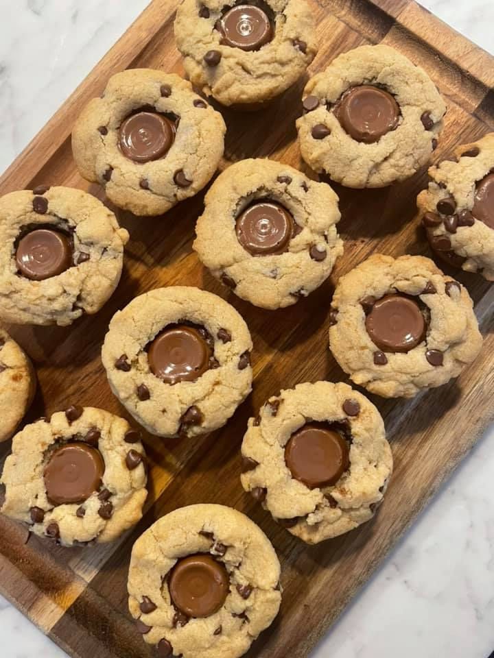 chocolate chip cookies are arranged on a wooden tray