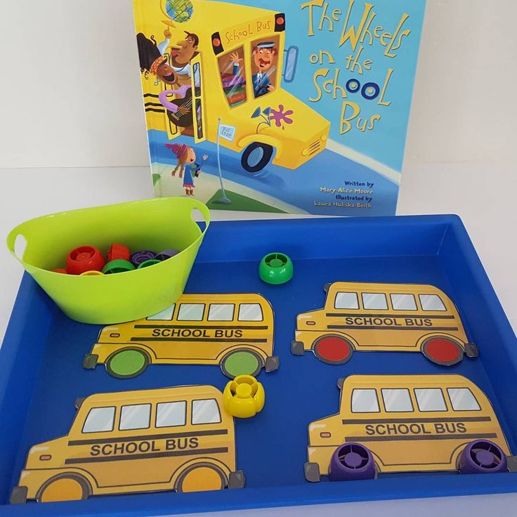 a blue tray with yellow school buses and a book