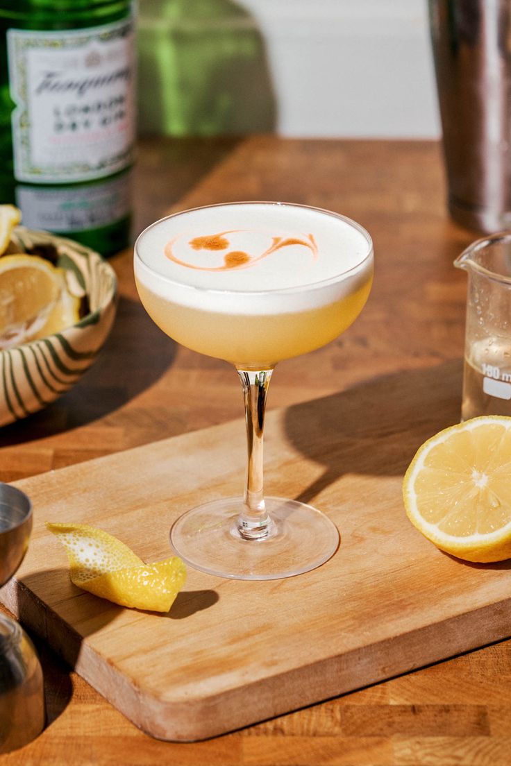 a drink sitting on top of a wooden cutting board