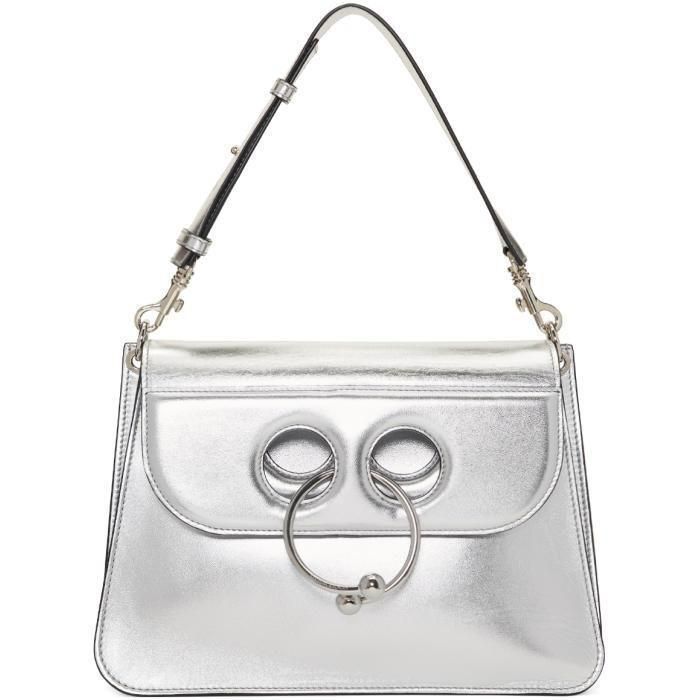 Silver Leather Medium Pierce Metallic Bag crafted in metallic goatskin, has a contemporary structure with a youthful vibe and adds that special pop to your evening chic look. Featuring double flap with circular barbell piercing closure, detachable shoulder strap, three internal compartments, soft leather lining and silver tone hardware. Signature dust bag included. Medium Size L 11½" x H 8" x W 3½"Strap drop 6½" adjustableMade in Italy Silver Purse, Clasp Purse, Metallic Handbags, Handbags White, Circular Barbell, Barbell Piercing, J W Anderson, Chloe Faye, Jw Anderson