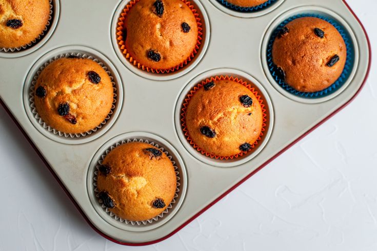 a muffin tin filled with blueberry muffins