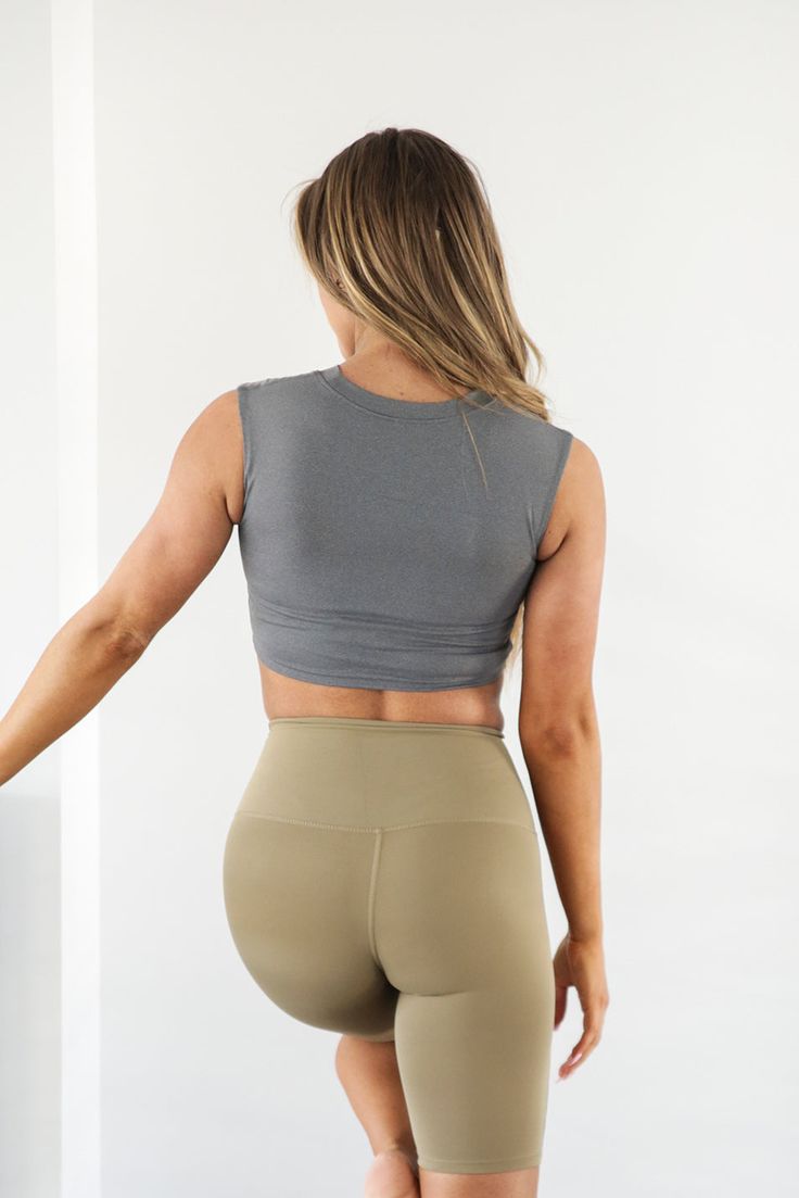 Embrace the sweat in this supportive Eva Essential Cropped Top. Sleek, soft and comfortable meets function in this workout top. Be confident during your next sweat sesh knowing you're covered. This sleeveless top has a cropped hem and high neck. Model is 5’5” wearing a size small Total Length of a small is 13.5" 72% Nylon, 28% Lycra Supportive Solid Color Sleeveless Activewear, Supportive Sleeveless Solid Activewear, Casual Moisture-wicking Crop Top For Pilates, Compression Crop Top For Gym, Cropped Sports Tank Top With Light Support, Sporty Moisture-wicking Crop Top Activewear, Sporty Moisture-wicking Crop Top For Yoga, High Stretch Sports Crop Top Activewear, Athleisure Tank Top With Supportive Light Support