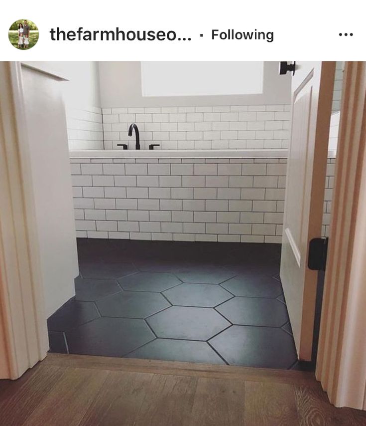 an open door leading to a bathroom with black and white tile