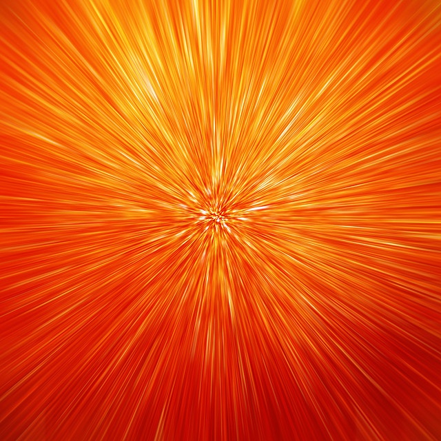 an orange and yellow background with lots of light streaks in the center, as well as some