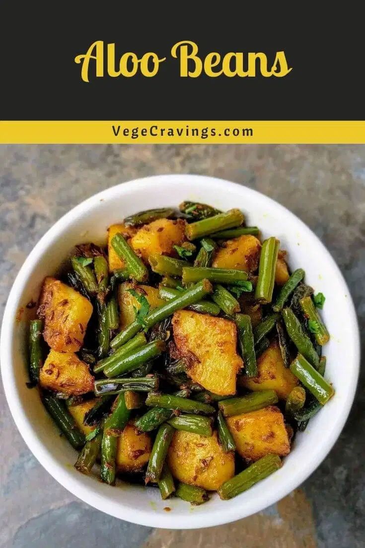 a white bowl filled with green beans and potatoes on top of a table next to a yellow border