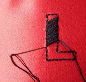 a close up of a piece of cloth with thread on it and an object in the middle