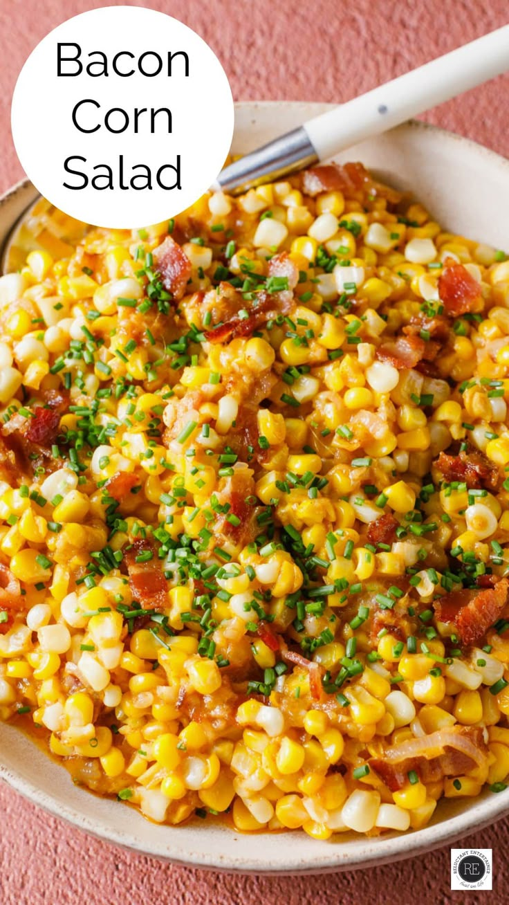 bacon corn salad in a white bowl on a pink surface with the words bacon corn salad above it