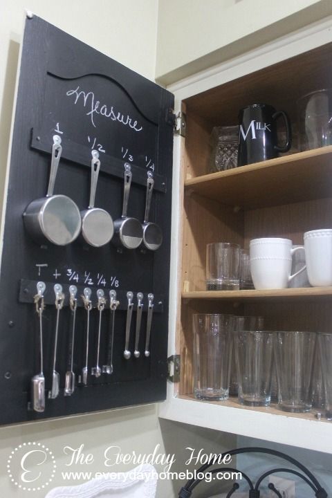 a kitchen cabinet filled with pots and pans