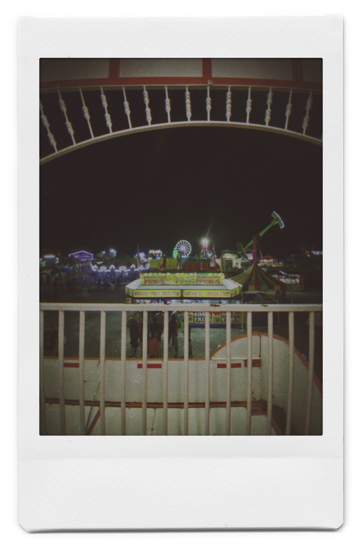 an old photo of a carnival ride at night